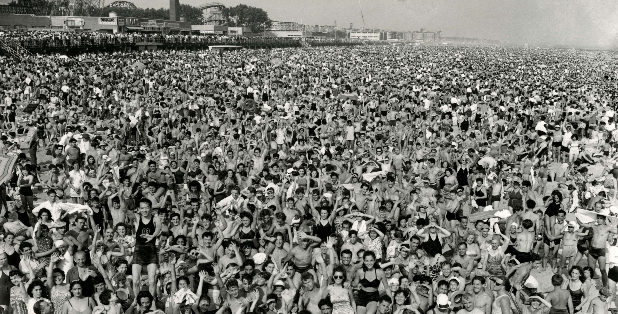 Weegee—Exposure  | Black and white phtograph of a crowd at Coney Island—faciing camera—1946.