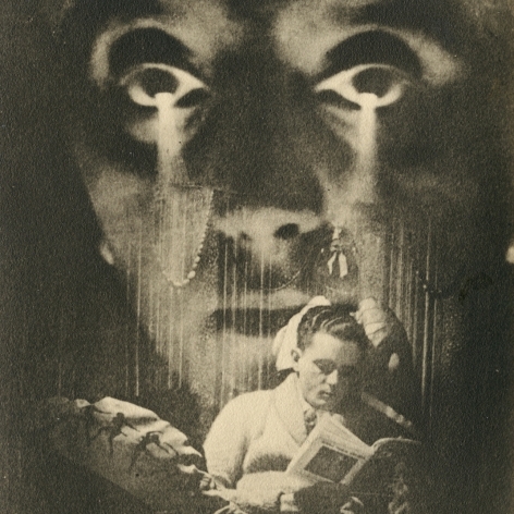 Black and white image of a man reading a book, with a large superimposed face of a woman looming over him.