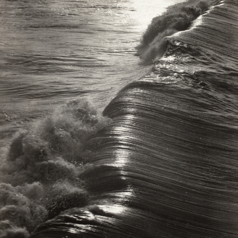 Black and white photo of a wave cresting. 